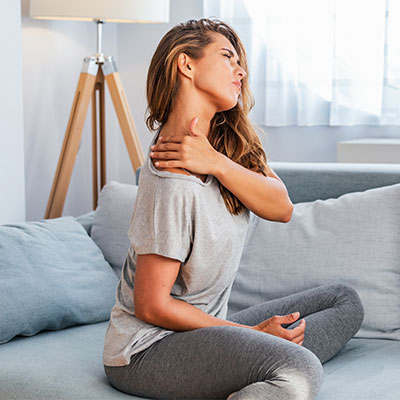 woman holding her neck in discomfort